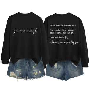 Black crewneck sweatshirt with inspiring quote and distressed blue denim shorts