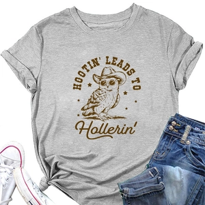 Flat lay of grey crew neck T-shirt with vintage owl print and denim shorts on white background