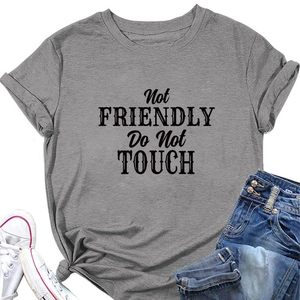 Close-up of grey t-shirt with Not Friendly Do Not Touch print and knotted hem detail