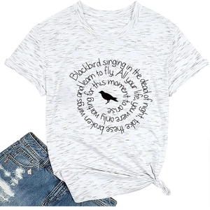 Detail of heather white t-shirt featuring bird print, song lyrics, and side knot hem