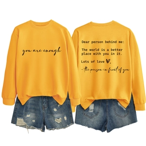 Bright yellow crewneck sweatshirt and ripped denim shorts with motivational text