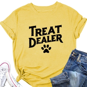 Detail of yellow cotton T-shirt featuring black Treat Dealer text and paw print