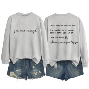 Front and back view of light grey crewneck sweatshirt with inspiring quote and denim shorts