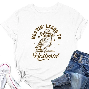 Flat lay of white short sleeve owl graphic tee with denim shorts and canvas sneakers
