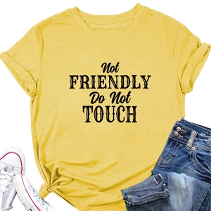 Macro detail of yellow cotton T-shirt featuring bold Not Friendly slogan and tied hem