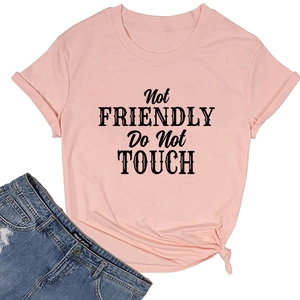 Close-up of Not Friendly Do Not Touch black graphic print on pink cotton t-shirt
