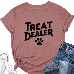 Detail view of pink Treat Dealer t-shirt featuring a pet paw print and letter graphics