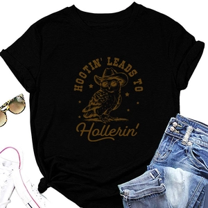Detail of a black crew neck T-shirt with vintage owl graphic and western lifestyle props