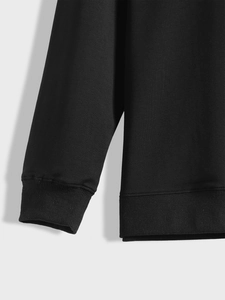 Detail of premium ribbed cuffs and hem on the black long sleeve sweatshirt