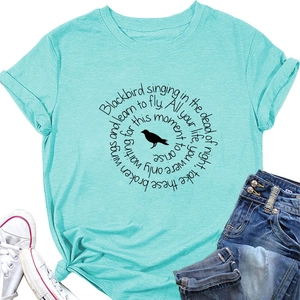 Detail of mint green cotton T-shirt featuring Blackbird lyrics and bird silhouette print