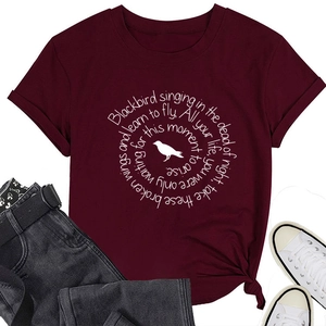 Flat lay of burgundy cotton T-shirt with white circular lyrics print and bird silhouette