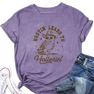 Detail of lilac t-shirt featuring owl print with knotted hem and stylish accessories