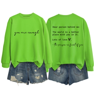 Neon green sweatshirt with inspirational back print paired with distressed denim shorts