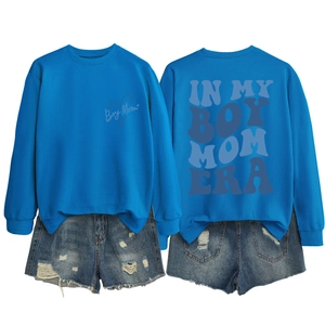 Flat lay of royal blue Boy Mom sweatshirt and ripped denim shorts with back print detail