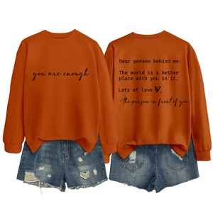 Detail view of the 'you are enough' letter print on a caramel crewneck sweatshirt