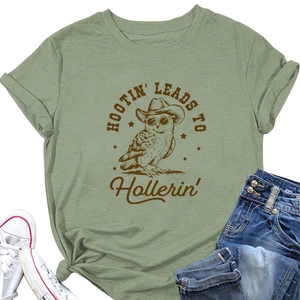 Flat lay of sage green cotton t-shirt with vintage owl graphic and denim pairing