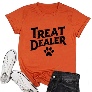 Flat lay detail of bright orange cotton t-shirt with black TREAT DEALER text and paw print