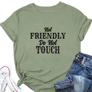 Detail of grey-green t-shirt with Not FRIENDLY Do Not TOUCH text and rolled sleeve cuffs