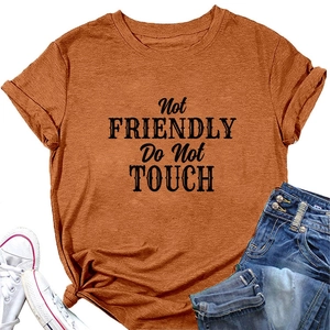 Detail of burnt orange t-shirt with black bold Not Friendly Do Not Touch lettering