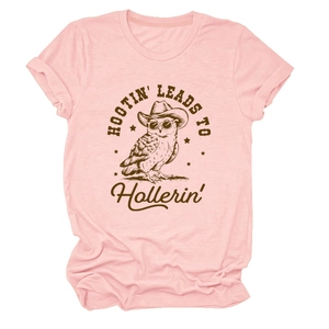 Close-up of pink cotton T-shirt featuring a vintage cowboy owl graphic and slogan