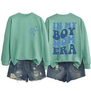 Front and back detail of mint green sweatshirt with In My Boy Mom Era blue print