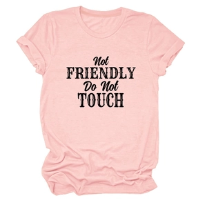 Detail of light pink T-shirt featuring bold Not FRIENDLY Do Not TOUCH text on the chest