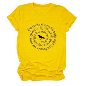 Detailed top-down shot of bright yellow cotton t-shirt featuring a black bird and spiral text