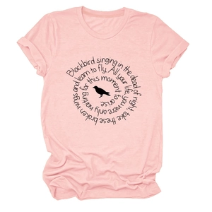 Close-up of pink t-shirt featuring black bird silhouette and circular lyrics print