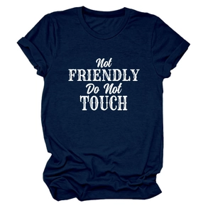 Detail of 'Not Friendly' white print on navy blue crew neck cotton t-shirt with rolled sleeves