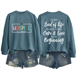 Detail view of the quote on back of blue-gray hospice nurse sweatshirt with denim shorts