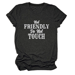 Detail of distressed white text print Not FRIENDLY Do Not TOUCH on dark gray t-shirt