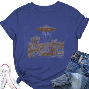 Detail of blue T-shirt featuring a retro UFO and cat graphic with desert landscape