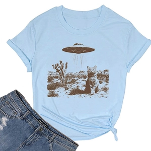 Close-up of cat and UFO print on a light blue cotton T-shirt with side knot detail