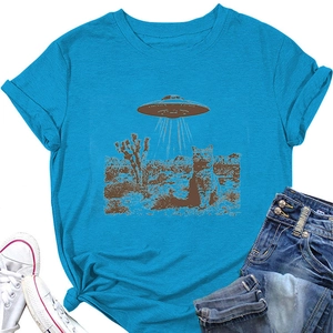 Flat lay of bright blue T-shirt featuring a cat and UFO desert print with denim shorts