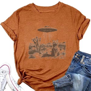 Detail of orange t-shirt with cat and UFO print paired with denim shorts