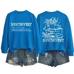 Flat lay view of blue Booktrovert sweatshirt with book and flower illustrations on the back