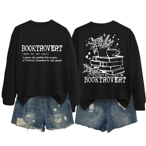 Flat lay of black Booktrovert sweatshirt with rose and book illustration and ripped shorts