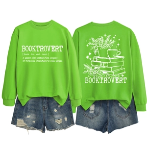Front and back view of Booktrovert neon green sweatshirt paired with ripped denim shorts