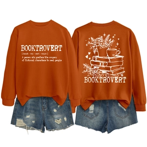 Detailed back view of orange sweatshirt featuring floral book and coffee line art