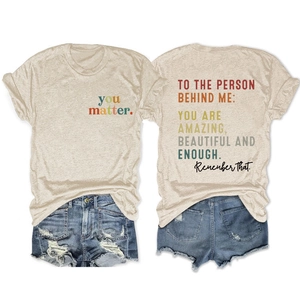 Front and back view of oatmeal crewneck T-shirt with inspirational text and denim shorts