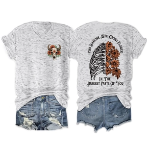 Flat lay of heather grey t-shirt with floral skull print and motivational back text