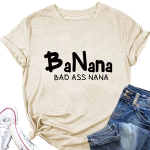 Flat lay of an oatmeal crew neck T-shirt with BaNana print and denim shorts