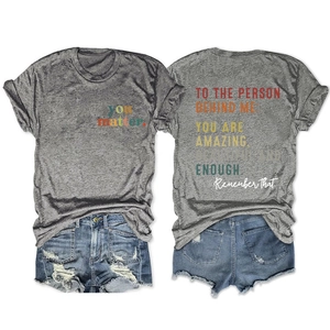 Front and back views of grey T-shirt with inspirational typography and denim shorts