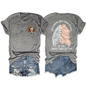 Flat lay of grey t-shirt with bull skull floral print and distressed denim shorts