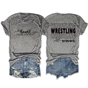 Flat lay of Wrestling Mom t-shirt showing front text and back graphic on grey fabric