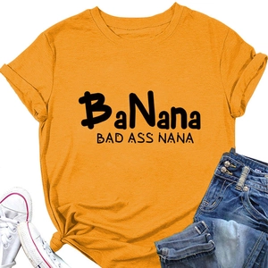 Close-up of mustard yellow t-shirt with BaNana Bad Ass Nana print and tied knot hem detail