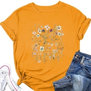 Flat lay of yellow floral t-shirt with knotted hem, denim shorts and white sneakers
