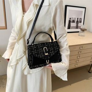 Elegant black and gold tweed crossbody flap bag with metallic weaving and chain strap