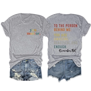 Detailed flat lay of gray T-shirt with 'you matter' text and distressed denim shorts
