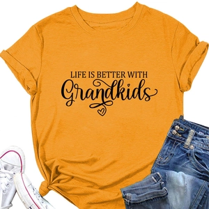 Flat lay of orange Life is Better with Grandkids T-shirt with jeans and shoes